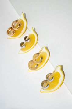 three slices of lemon with gold rings on them