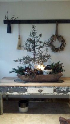 a wooden table topped with a potted pine tree