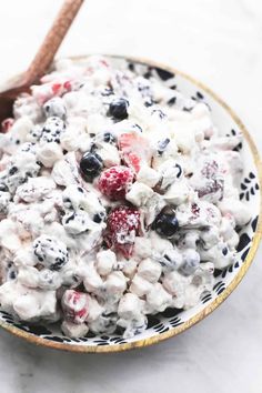 a bowl filled with fruit salad on top of a table