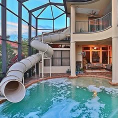 an instagram photo of a house with a slide in the pool