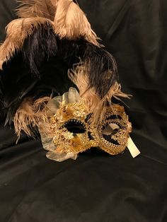 "This mask with feathers belongs to our collection of masks \"Lady Plumes\". The fetaher masks are the most elegant, refine and stunning masks of our collections. This mask is a traditional and original papier-mache Venetian mask, handmade and decorated in our Atelier in Venice using velvet , fabrics, Swarovski, feathers, different trimming. It is perfect for any masquerade party, Halloween costume, pro or event in Venice or elsewhere during Carnival. This mask can be gently bent to form to your Elegant Masquerade Eye Mask, Elegant Masks For Mardi Gras Costume Party, Elegant Carnival Masks For Costume Party, Elegant Masks For Costume Party And Carnival, Elegant Evening Mask For Carnival, Elegant Evening Masks For Carnival, Elegant Masquerade Mask For Carnival, Elegant Formal Mask For Carnival, Artistic Formal Masks For Mardi Gras