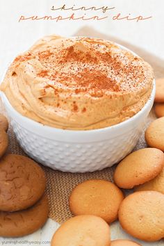 a bowl of pumpkin pie dip surrounded by cookies on a table with text overlay