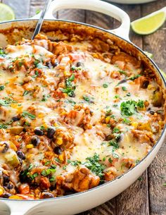 a casserole dish filled with mexican food and garnished with cilantro