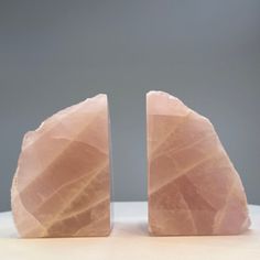 two pink stone sculptures sitting on top of a table