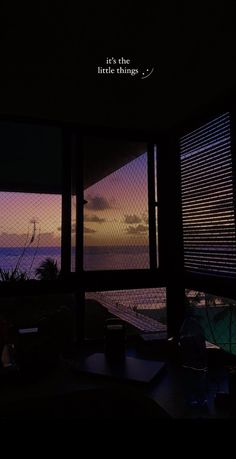 the view from inside a house looking out at water and clouds in the distance with words above it