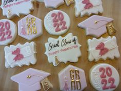 decorated cookies with graduation caps and tassels are arranged on a wooden table top