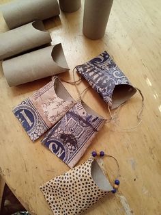 several rolls of toilet paper sitting on top of a wooden table next to rolled up toilet paper