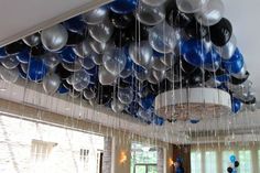 a room filled with lots of balloons hanging from the ceiling