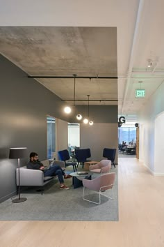 a man sitting on a couch in an office