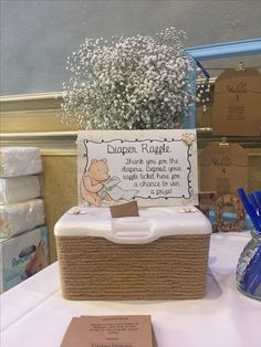 a winnie the pooh diaper raff basket with baby's breath flowers in it