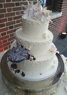 a white wedding cake with flowers on top