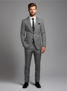 Explore the nuances of fabric and fit with our comprehensive London Loom Gray Nailhead Wool Silk Linen Suit. Crafted from a luxurious blend of wool, silk, and linen, this suit epitomizes the marriage of comfort and refinement. Wrapped in a shade of solid gray and perfectly complemented by a subtle nailhead pattern that adds depth and texture, it enhances its refined charm, making it equally suitable for formal gatherings and leisurely engagements.   The  London Loom Collection   masterfully blends the durability of wool, the luxury of silk, and the breathability of linen, reflecting the elegance of English tailoring. This fabric offers season-spanning comfort, refined drapes, and natural coolness. Woven with traditional expertise, it stands as a testament to quality, style, and exquisite c Modern Tailored Wedding Suits, Modern Notch Lapel Suits For Wedding, Wool Suit With Notch Lapel For Wedding, Notch Lapel Wool Suit For Wedding, Wool Notch Lapel Suits For Wedding, Modern Fitted Sets For Workwear, Fitted Wool Suit For Wedding, Modern Tailored Suit In Suiting Fabric, Modern Fitted Wedding Suits