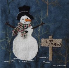 a snowman is standing next to a sign