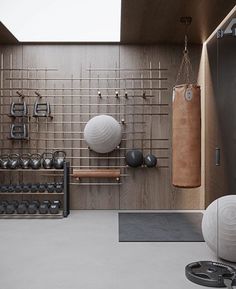 there is a gym with balls, kettles and exercise equipment on the wall in this room