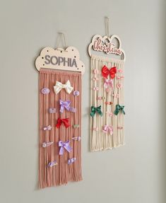 two wall hangings with bows on them