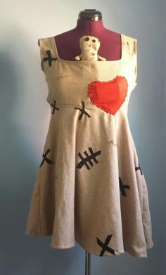 a dress on a mannequin with red heart and crossbones painted on it