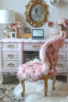 a pink chair sitting in front of a desk with a clock on the wall above it