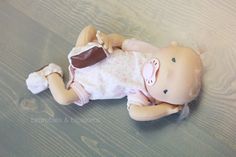 a baby doll is laying on the floor