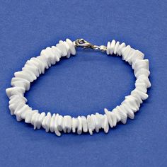 a bracelet with white beads on a blue background