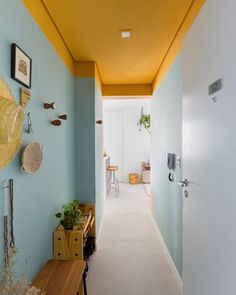 a long hallway with blue walls and yellow ceiling