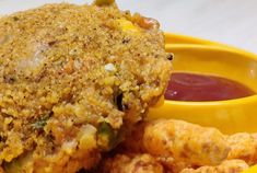 fried food with dipping sauce in yellow bowl