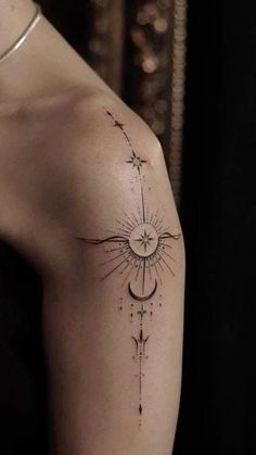 a woman's arm with a tattoo on it that has an image of the moon and stars