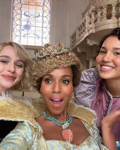 three women dressed as princesses posing for the camera