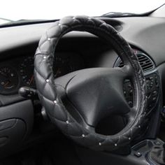 the steering wheel cover is black and has silver studding on it's sides