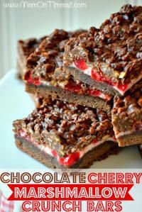 several pieces of cake on a plate with nuts and strawberries in the top layer