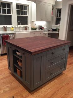 a large kitchen island sitting in the middle of a wooden floor