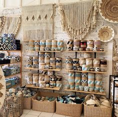 baskets and other items are on display in a store with wall hangings behind them