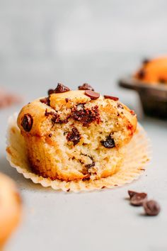 a muffin with chocolate chips sitting on top of it