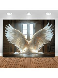 a large white bird with its wings spread out in front of an open window on a wooden floor