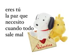 two stuffed animals sitting on top of an envelope with the words valentine written in spanish