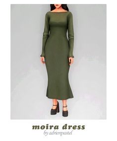 a woman wearing a green dress with long sleeves and black heels, standing in front of a