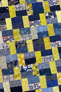 a patchwork quilt with yellow and blue squares