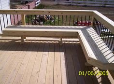 a wooden bench sitting on top of a wooden deck