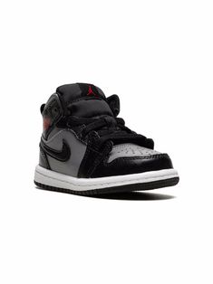 a pair of black and grey sneakers with white soles on a white background, the air jordan 1 mid