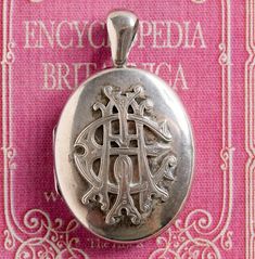 Gorgeous extra-large Victorian 19th century English sterling silver locket pendant with beautiful decoration and raised AEI initials on the front. . The AEI stands for Amity, Eternity and Infinity which, during the Victorian period, was a popular symbol and would have been worn as a sign of everlasting love. The nice-sized locket dates to the 1880s and measures 2-1/4" including the bale. It is 1-3/8" wide and opens to hold two photos. No glass in the interior. We are including a 24" long silver Victorian Oval Jewelry With Initials, Vintage Sterling Silver Jewelry With Initials, Victorian Silver Jewelry With Engraving Option, Vintage Oval Monogram Jewelry, Infinity Locket, Sterling Silver Locket, Silver Locket, Metal Ball, Everlasting Love