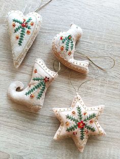 three ornaments are sitting on a table together