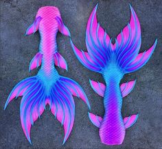 two pink and blue fish are on the ground