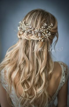 a woman with long blonde hair wearing a bridal headpiece