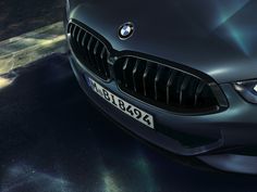 the front end of a black bmw car