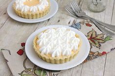 two small pies sitting on top of white plates