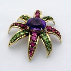 "Vintage large flower form 18 K (.750) yellow gold brooch, having oval Amethyst centerpiece. Alternating petals are decorated with graduated Pink Tourmaline and Peridot stones. This stunning brooch is 2 3/8\" long, 2 1/4\" wide and weighs 51.6 grams. The amethyst measures 19.7 mm x 15.7 mm. EA1936" Elegant Multi-stone Oval Brooches, Elegant Multi-stone Oval Brooch, Elegant Oval Multi-stone Brooches, Peridot Brooch, Amethyst Flower, Gold Brooch, Peridot Stone, Amethyst Jewelry, Gold Brooches