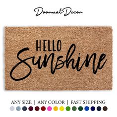 a door mat with the words hello sunshine on it in black and white, surrounded by colors