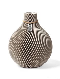 a brown vase with a tag on it's side and wavy lines in the front