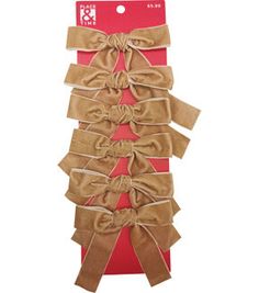 the package is wrapped in brown and red paper with bows on each side, which are tied together