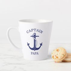 a cup and some cookies sitting on a table with the capt captain papa printed on it