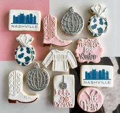 decorated cookies are arranged on a table with the names nashville and other city emblems